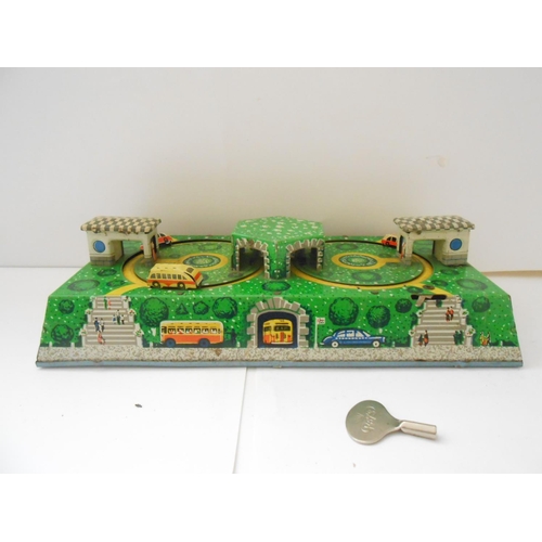 373 - A German WV tin plate clockwork bus station toy - 9 1/2in. wide and a Japanese TPS friction tin plat... 