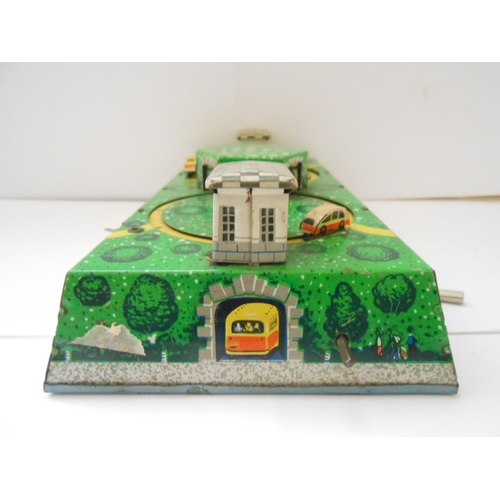 373 - A German WV tin plate clockwork bus station toy - 9 1/2in. wide and a Japanese TPS friction tin plat... 