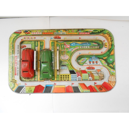 373 - A German WV tin plate clockwork bus station toy - 9 1/2in. wide and a Japanese TPS friction tin plat... 