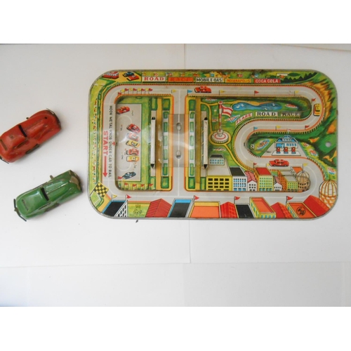 373 - A German WV tin plate clockwork bus station toy - 9 1/2in. wide and a Japanese TPS friction tin plat... 