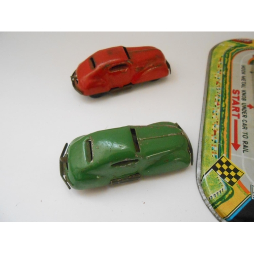 373 - A German WV tin plate clockwork bus station toy - 9 1/2in. wide and a Japanese TPS friction tin plat... 