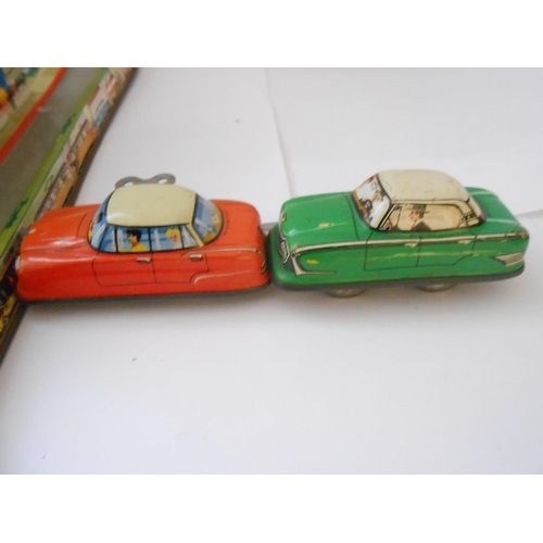 375 - A Western Germany 1960 tin plate clockwork road circuit and two cars - 13in. x 12in. (possibly Techn... 