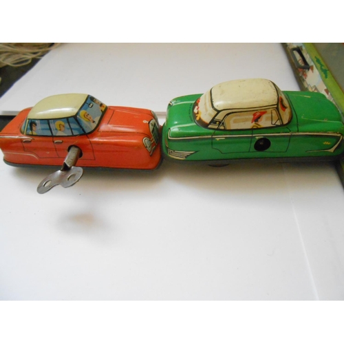 375 - A Western Germany 1960 tin plate clockwork road circuit and two cars - 13in. x 12in. (possibly Techn... 