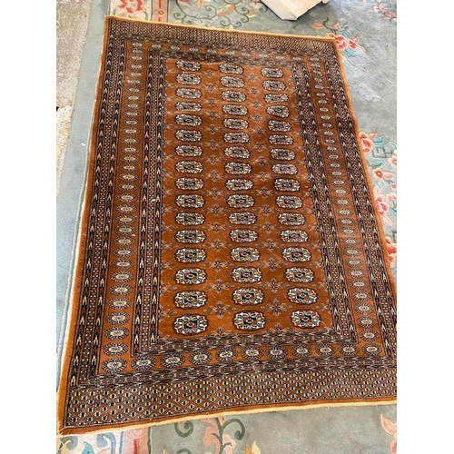 4 - A Bokhara rug, brown field with repeating medallions  - 48in. x 72in.