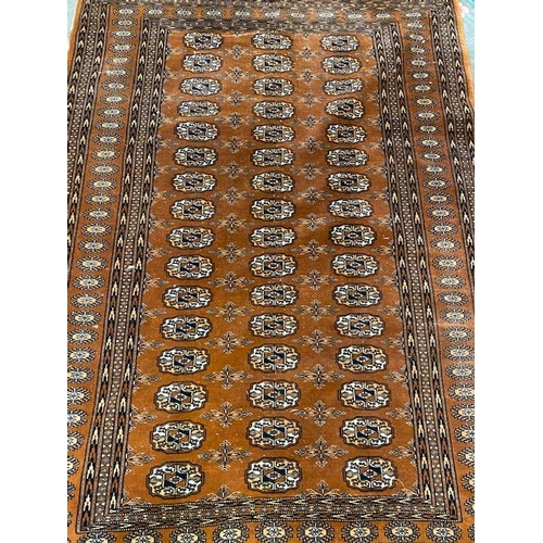 4 - A Bokhara rug, brown field with repeating medallions  - 48in. x 72in.