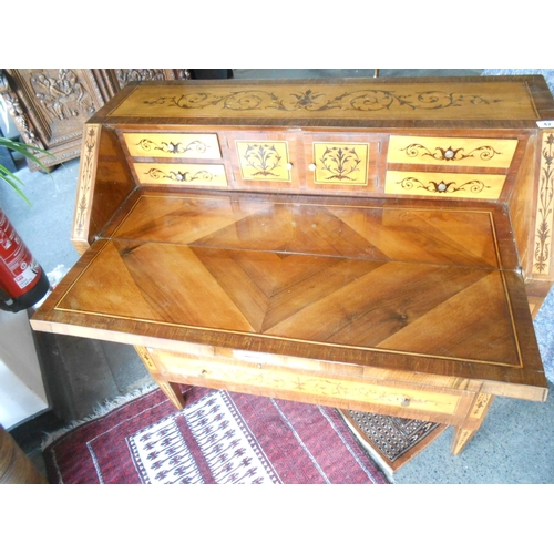 42 - An Italian walnut and inlaid bureau with hinged fall front enclosing central cupboards and drawers a... 