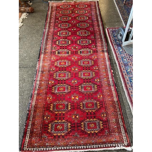 6 - An Eastern rug, red field with twenty four medallions, fringed - 110in. x 42in. and one other Easter... 