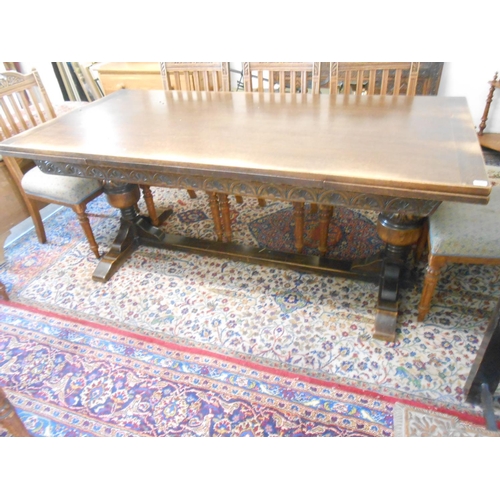 63 - An oak refectory style drawleaf dining table on carved bulbous supports - 64in. wide