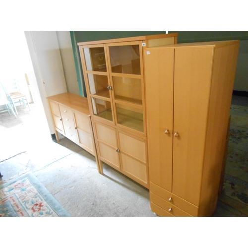 69 - A light oak effect cabinet fitted two glass doors above two panelled doors, on tapering legs - 36in.... 