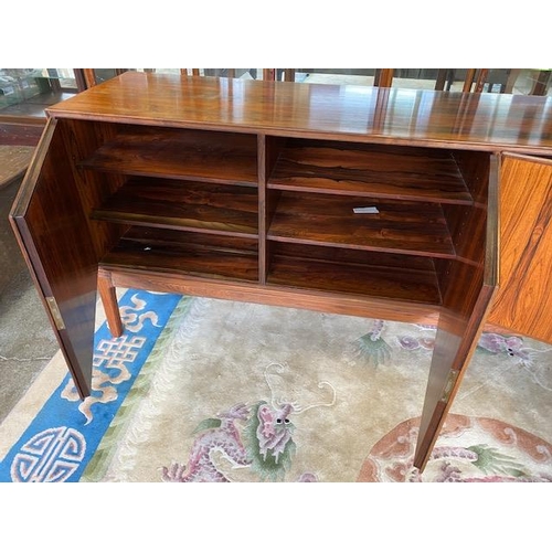 98 - A Danish rosewood dining room suite comprising:- Skovby  Furniture Factory dining table with two ext... 