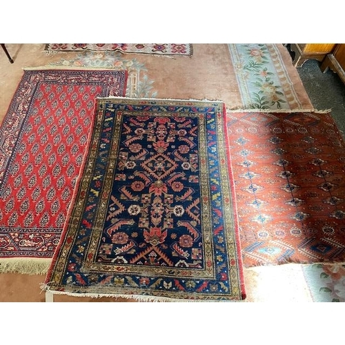 7 - A Persian rug, blue field with red geometric decoration, fringed - 55in. x 39in., a Bokhara rug - 44... 