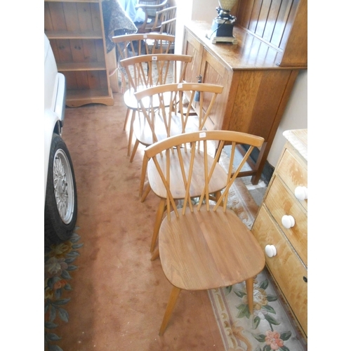 94 - A set of four Ercol style light elm kitchen chairs with stick backs and hard seats