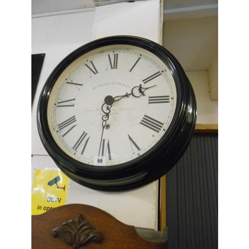 96 - A large circular wall clock by Newgate of London, in a black metal case