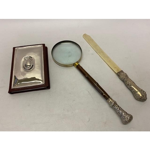 151 - A page turner with repousse decorated silver handle - London 1906, a magnifying glass with repousse ... 