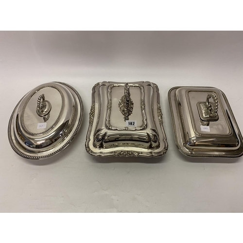 182 - A rectangular silver plated entree dish and cover with leaf scroll handle, an oval silver plated ent... 