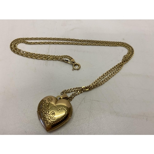 214 - A 9ct. gold chain with a 9ct. gold heart shaped locket