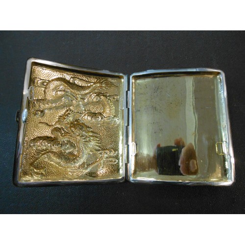 194 - A silver coloured metal cigarette case, the front inset with hammered silver coloured metal panel de... 