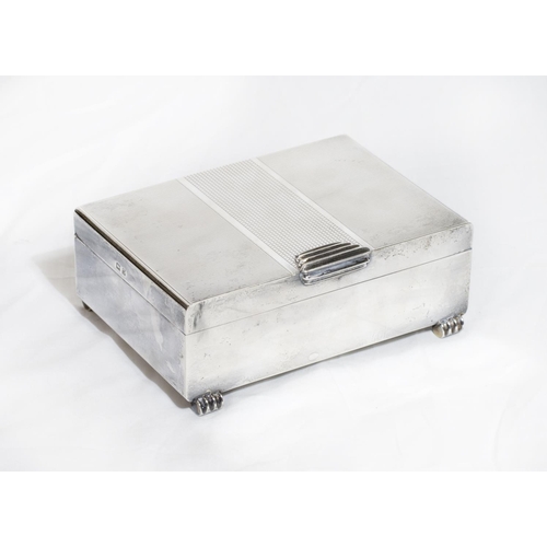 124 - A rectangular silver Art Deco design cigarette box with engine turned decoration, on scroll feet - B... 