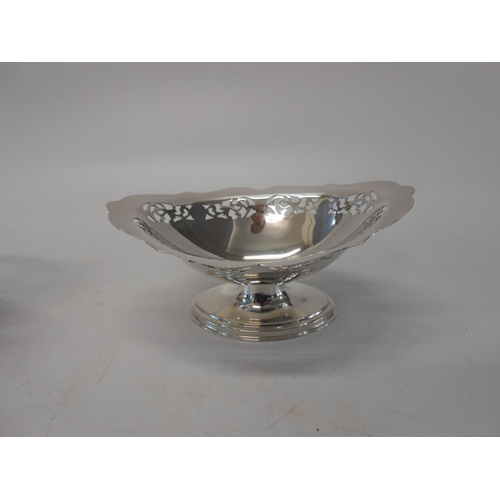 138 - A pair of silver navette shaped sweetmeat dishes with pierced borders, on pedestal and oval foot - S... 