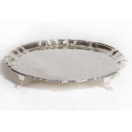 152 - A silver card tray with serpentine edge, on hoof feet - Chester 1908, makers marks for Herbert and F... 