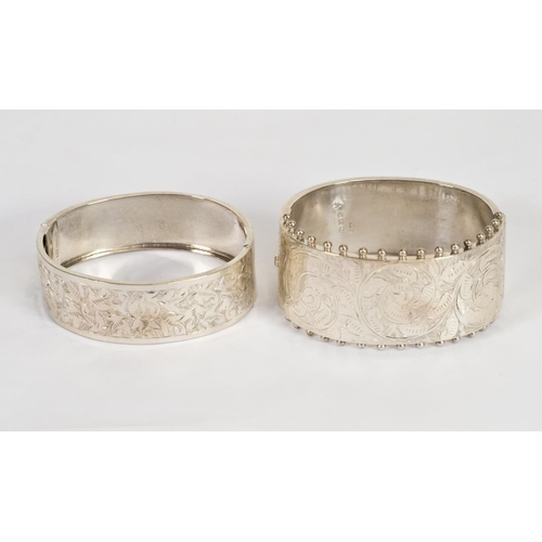 169 - A Victorian silver hinged bangle with engraved decoration to the top - Birmingham 1884, makers marks... 