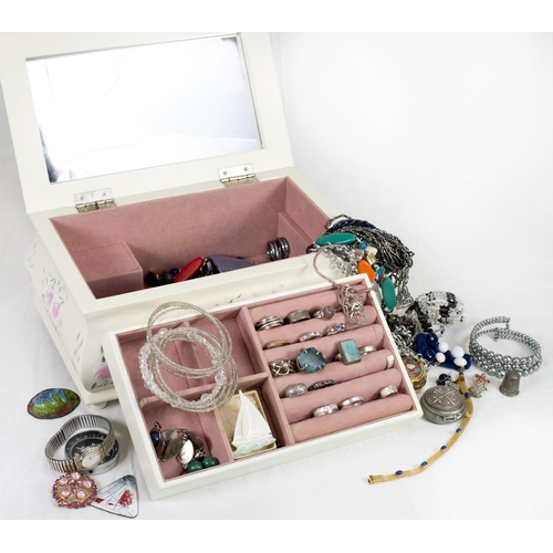 187 - A cream jewellery box containing a selection of costume jewellery including rings, bead necklaces, b... 