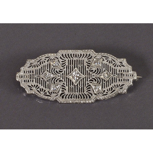 192 - A white gold coloured metal plaque form brooch of pierced design set diamonds