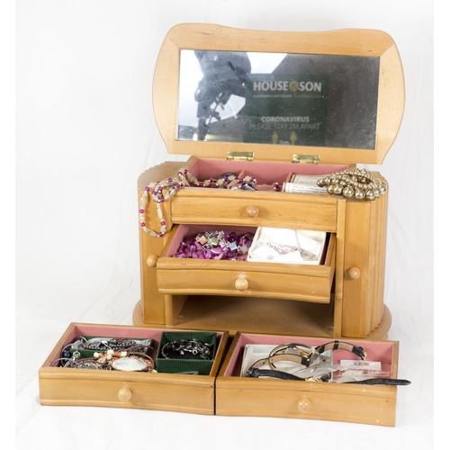 204 - A jewellery box in the form of a chest of drawers containing a small selection of costume jewellery ... 