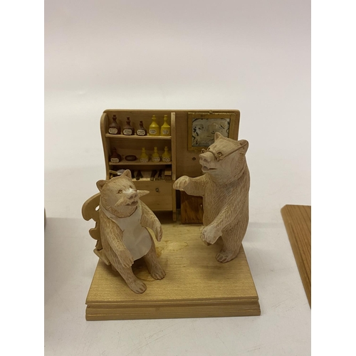 260 - A wooden box containing two small carved wood bears in an interior setting