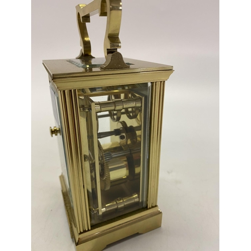 273 - A carriage clock retailed by Mappin and Webb, white enamel dial, in a brass and glass panelled case