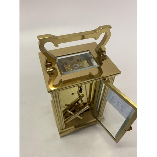 273 - A carriage clock retailed by Mappin and Webb, white enamel dial, in a brass and glass panelled case