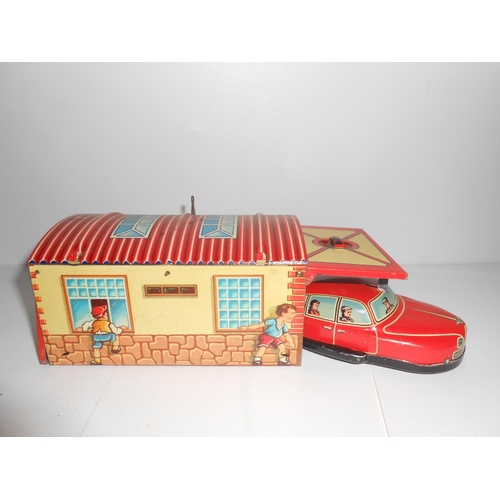 359 - A Lehmann Gnom 806 - 4 1/2in. long and a Western Germany tin plate car and garage - 5 1/2in. long