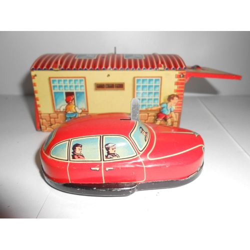 359 - A Lehmann Gnom 806 - 4 1/2in. long and a Western Germany tin plate car and garage - 5 1/2in. long