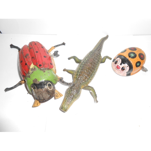 360 - A clockwork tin plate beetle - 6 1/4in. long, a clockwork tin plate crocodile - 9in. long and a Japa... 