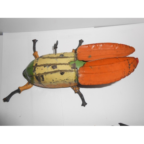 360 - A clockwork tin plate beetle - 6 1/4in. long, a clockwork tin plate crocodile - 9in. long and a Japa... 