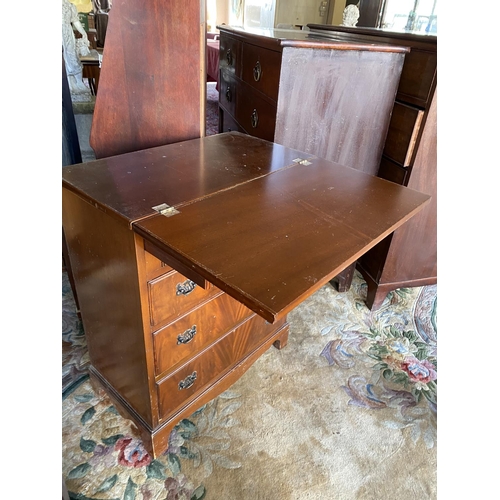 74 - A reproduction mahogany bachelors chest with folding top, fitted four drawers, on bracket feet - 25i... 