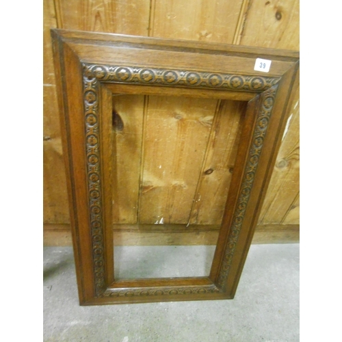 39 - An oak picture frame with carved decoration - 31in. x 20in. and a small carved gilt wood Florentine ... 