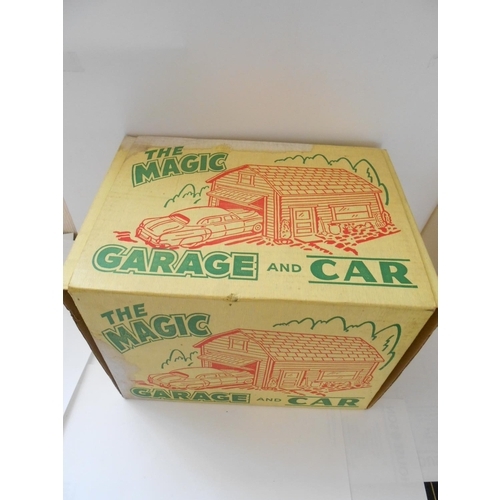 375 - A Louis Marx Magic Garage and Car, boxed - 10 1/2in. long and 8 1/2in. high