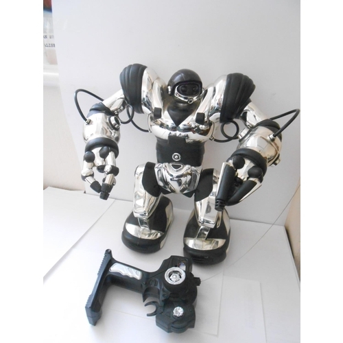 377 - A remote control robot - 14in. high, a battery operated robot - 16in. high and a fabric doll - 22in.... 