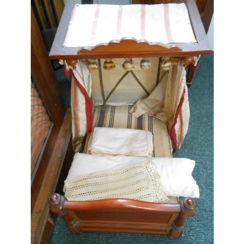 378 - A dolls mahogany framed bed - 19in. x 14in. x 19in.