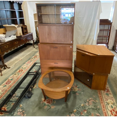 57 - A 1970's teak and glass free standing corner cabinet on black metal legs and a similar coffee table ... 