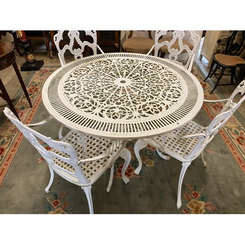 46 - A white patio table and four chairs