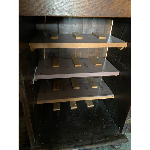 120 - An antique and later oak dresser, the raised back fitted cup hooks and shelves, the base fitted cent... 