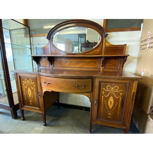 25 - An Edwardian mahogany and inlaid sideboard, the raised back fitted oval bevelled mirror, the base fi... 