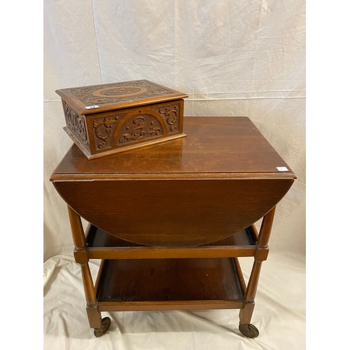 40 - An oak three tier tea trolley fitted two drop flaps - 24in. wide and an oak box with carved scrolls ... 