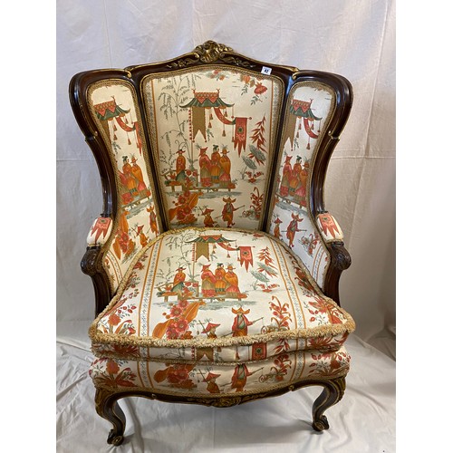 42 - A French style armchair with carved gilt frame, upholstered in Chinese style fabric, on cabriole leg... 