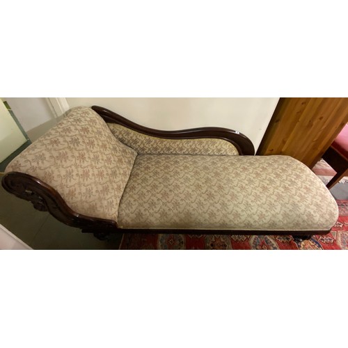 41 - A 19th Century mahogany framed chaise longue with scroll back, leaf carved decoration, upholstered i... 