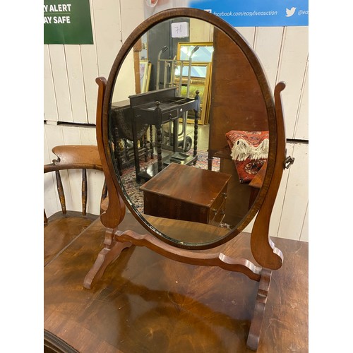 70 - An oak magazine rack, an oak firescreen with carved panel, a mahogany framed oval swing toilet mirro... 