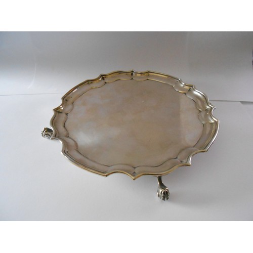 192 - A silver card tray with serpentine border, on three claw feet - London 1972, makers marks for A Chic... 