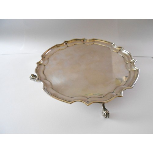 192 - A silver card tray with serpentine border, on three claw feet - London 1972, makers marks for A Chic... 